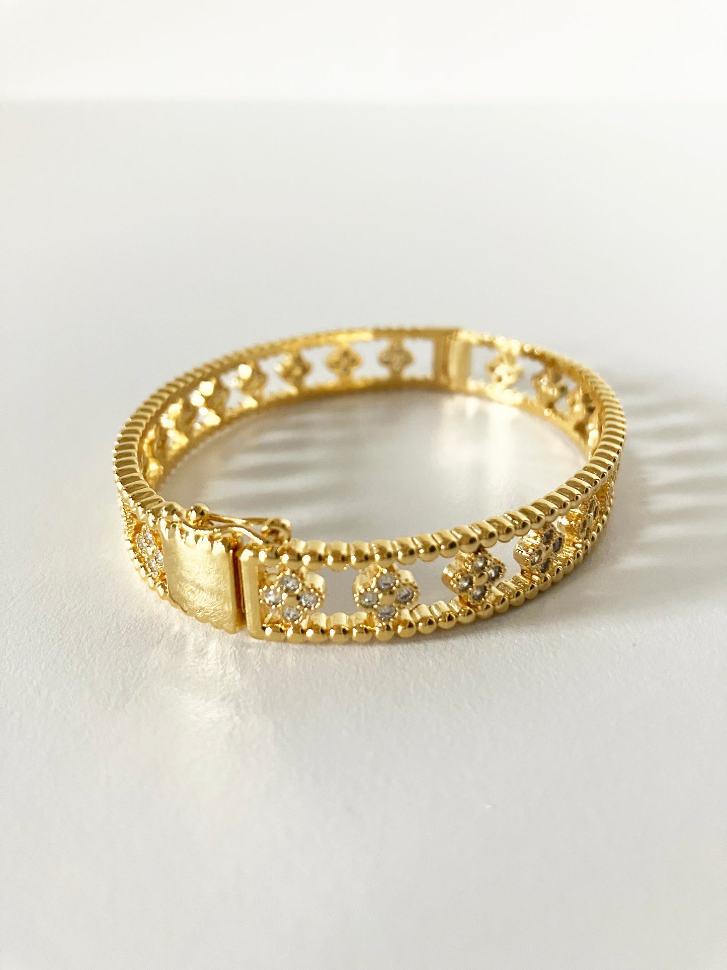 Small Floral Openwork Bangle in Gold and Cubic Zirconia